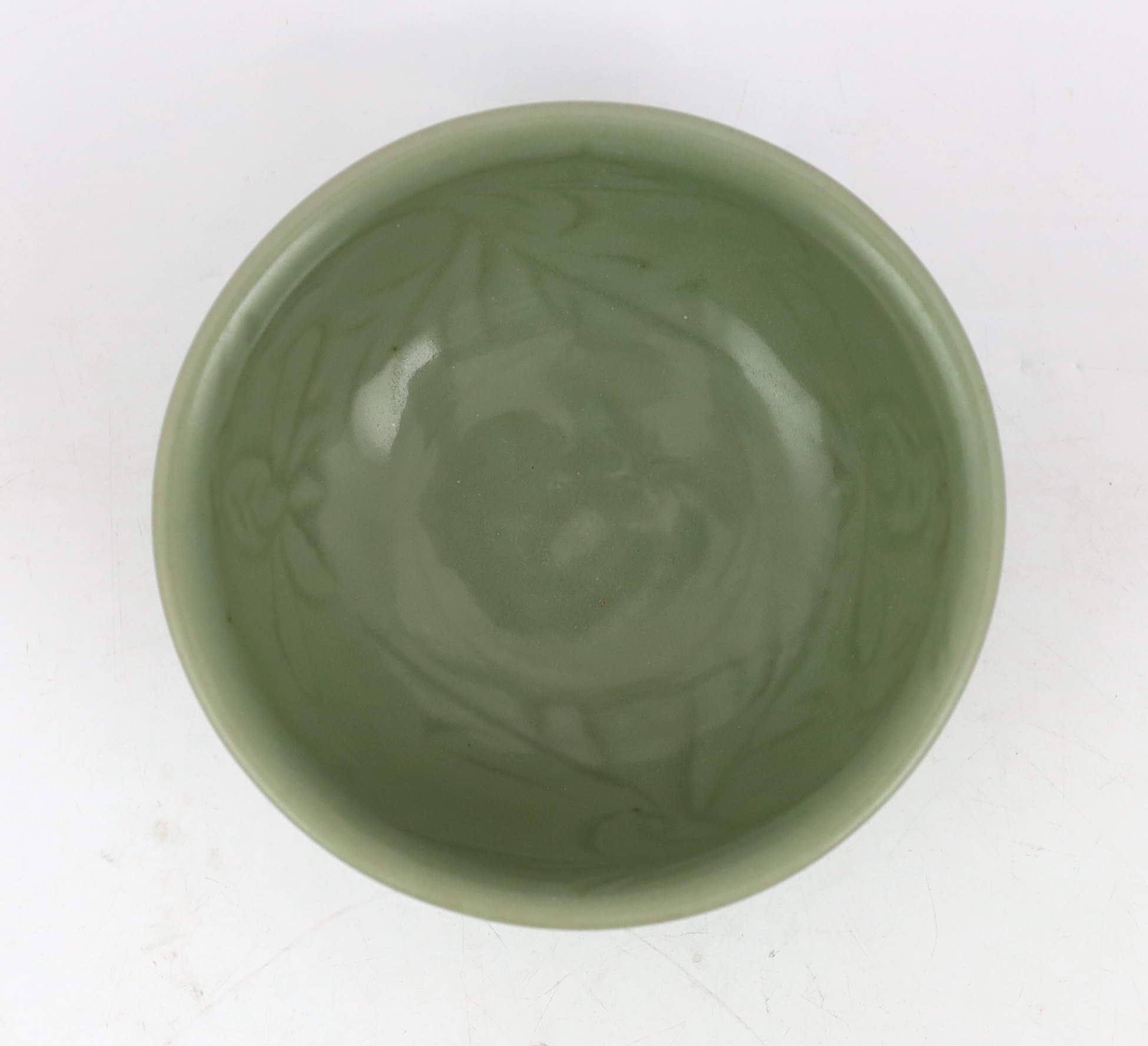 A Chinese Longquan celadon bowl, the interior carved with lotus flowers and the exterior with foliate lappets, 15.2cm diameter., Provenance - Robert Ricketts collection, formerly sold by Robert McPherson, London and S. M